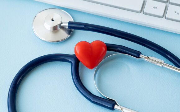 Stethoscope, Heart, Keyboard And Notepad On Tile Background
