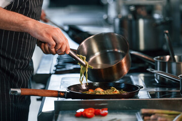 Busy at work. Chef is on the kitchen preparing food