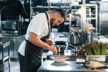 Fototapeta premium Delicious salad. Chef is on the kitchen preparing food