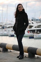 Portrait of a brunette girl looking into the distance in winter in the port in Sochi Russia - 522923748
