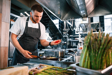 Focused on making delicious salad. Chef is on the kitchen preparing food