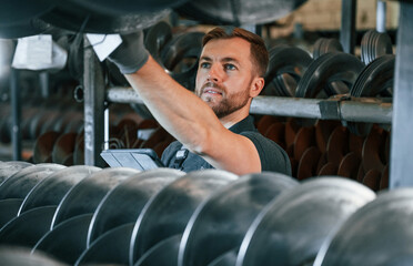 Quality test. Man in uniform is in workstation developing details of agriculture technique