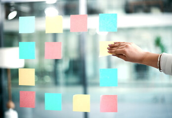Business woman planning company growth and strategy by arranging sticky notes and managing her...