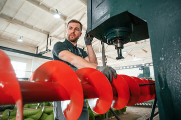 Professional engineer operating machine. Man in uniform is in workstation developing details of agriculture technique