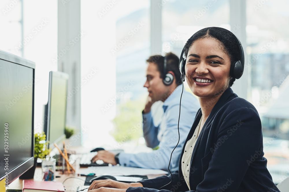 Poster portrait of happy call center agent working in a busy office, assisting clients and providing good c