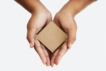 Closeup of the hands of a person showing a message, advertising a product or holding an empty paper or a cardboard card against a white background. Top view of woman promoting an item or sign