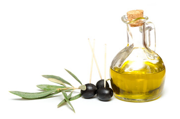 Olive oil in a bottle with olives and a olive twig