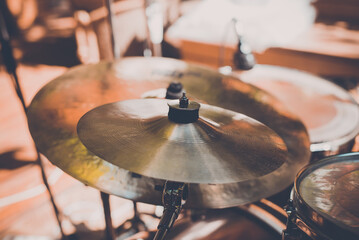 Obraz premium Drum kit at concert, hi-hat cymbals at street music festival on sunny day. Close-up, selective focus, toned image