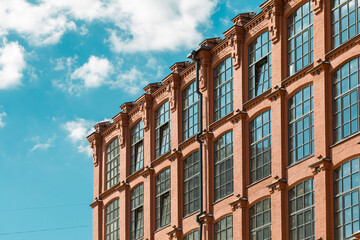 Fototapeta na wymiar Loft building facade. Windows of the factory building.