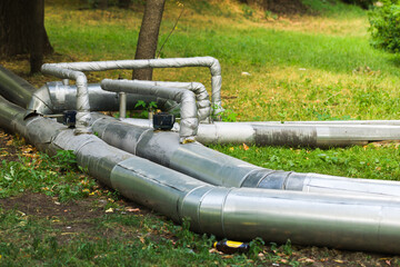 Pipeline on the lawn. Pipes on the grass.