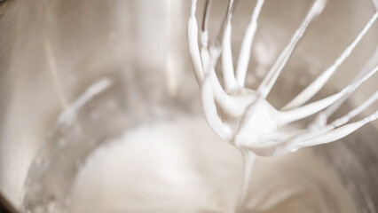 Mixing Whipped Cream in a Stand Mixer with a Whisk Attachment: Heavy whipping cream mixed with a stand mixer wire whisk