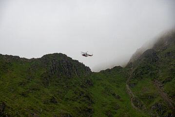 The Hm RescueGuard rescue helicopter, above Helvellyn Peak in the National Park Lake District 2022