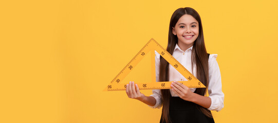 smiling kid in school uniform hold mathematics triangle for measuring, math. Banner of school girl student. Schoolgirl pupil portrait with copy space.