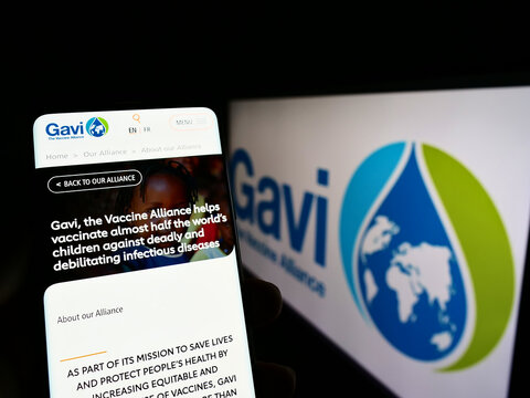 Stuttgart, Germany - 07-31-2022: Person holding cellphone with website of health partnership Gavi, the Vaccine Alliance on screen with logo. Focus on center of phone display.