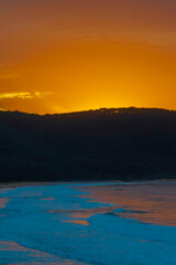 Vivid Orange and Blue Sunrise Seascape with Headland