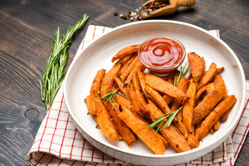 Vegan food baked Sweet Potatoes chips on a wooden Background