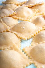 Making homemade ravioli, italian cuisine, uncooked pasta.