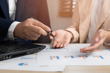 Obraz premium Business persons discuss on paper document chart and graph report teamwork and leadership concept