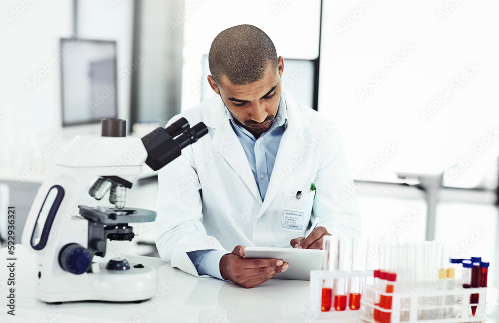 Aufkleber Scientist writing DNA results from microscope test on a tablet.Professional male doctor in a lab working with research tubes.Man in a modern laboratory doing medical science data analysis.
