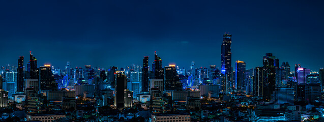 Concept of financial business Technology and travel in Asia cityscape urban landmark,bangkok at night district dusk sky.Thailand night city skyline with modern Bangkok skyscraper architecture building
