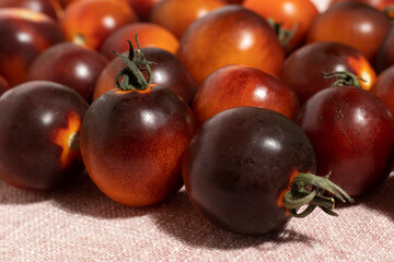 Black strawberry tomatoes on the table. Close up.