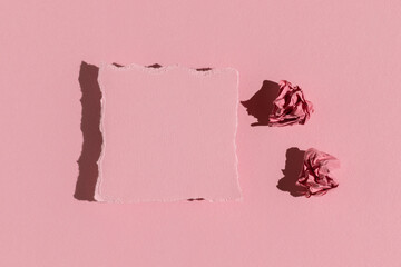 Pink greeting card on a pink background. Hard light, top view.