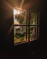 A beautiful summer view from finnish sauna window. Sunbeams shining through window.