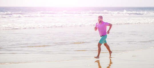 Man running and jumping, banner with copy space. healthy man running on beach. energetic summer. runner feel freedom. enjoying the morning.