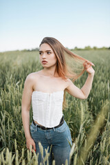 Beautiful girl posing in wheat field. Emotions of a girl