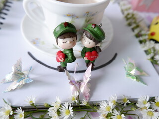 A white coffee mug under the beautiful atmosphere of the sweetness of love decorated with flowers.