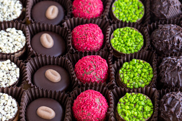 Packed chocolate. Assortment of packed truffle chocolates on a white background. close up