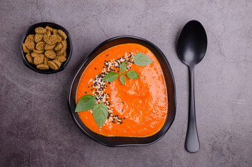 Red cream soup with sesame and basil