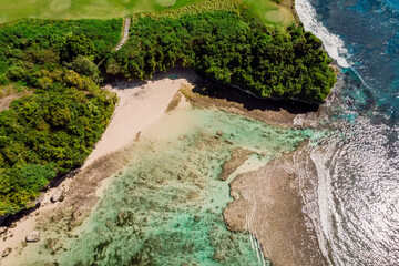 Aerial view of beach and low tide in ocean at Bali, Balangan.