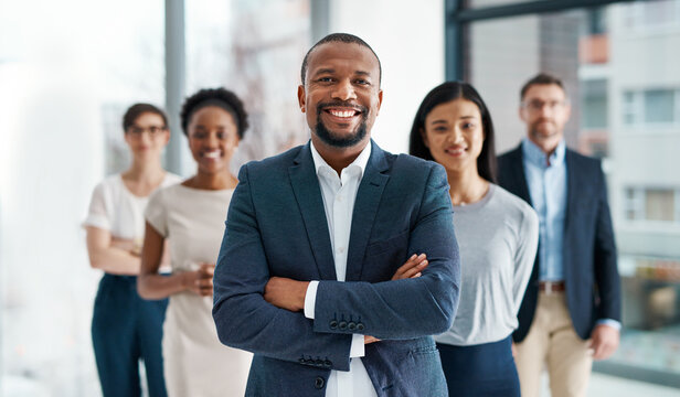 Professional, diverse and successful business team smiling and standing together in an office. Happy, formal and multiracial corporate staff, bank workers or businesspeople looking at camera.