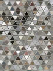 pebble patterns from many grey and white smooth stones arranged to form creative triangular mosaic designs