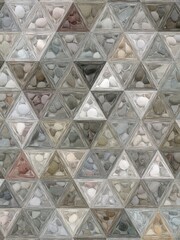 pebble patterns from many grey and white smooth stones arranged to form creative triangular mosaic designs