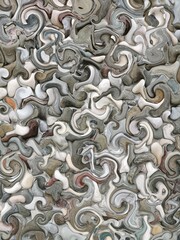 pebble patterns from many grey and white smooth stones arranged to form creative turbulence designs