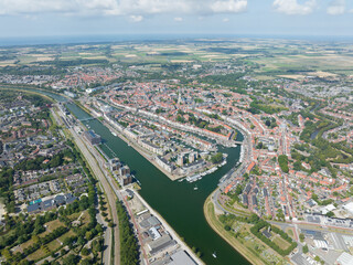 Fototapeta na wymiar Middelburg is the capital city in the Dutch province of Zeeland on the former island Walcheren. urban skyline and city overview. Aerial drone overview of old city center canals and cultural heritage.