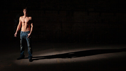 Shadowplay. Series of images of casually dressed models in a dark and industrial setting experimenting with light.