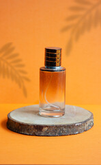 bottle of perfume on orange background