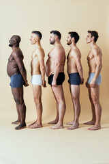 group of multiethnic men posing for a male edition body positive beauty set. Shirtless guys with...