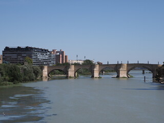 Stony bridge of lions and Ebro river in Saragossa city in Spain