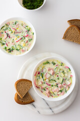 Cold soup Okroshka, soup with fresh vegetables and kefir, delicious summer traditional Ukrainian or Russian soup