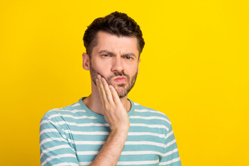 Photo of sick guy hand cheek wear striped t-shirt isolated on yellow color background
