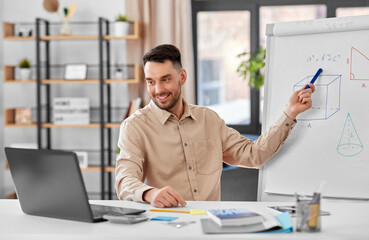 distant education, school and remote job concept - happy smiling male math teacher with laptop...