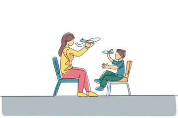 One continuous line drawing of young mother and her daughter sitting on chair and playing airplane toy together at home. Happy family parenthood concept. Single line draw design vector illustration