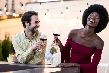 Family and friends celebrating at dinner on a rooftop terrace