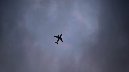Fototapeta na wymiar Aeroplane against stormy black sky