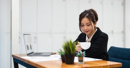 business woman or accountant working on calculator to calculate business data, accountancy document and laptop computer at office, business concept