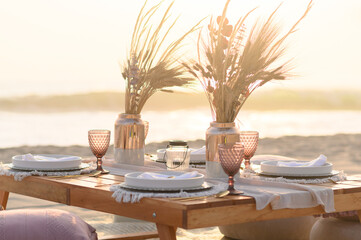 Served banquet table with elegant decorations and plates with cutlery